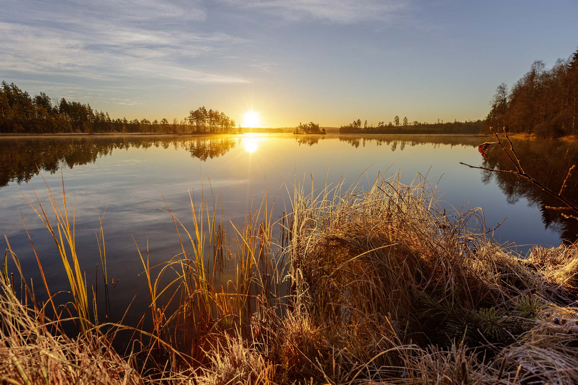 Sunrise over a calm lake in a Nordic landscape