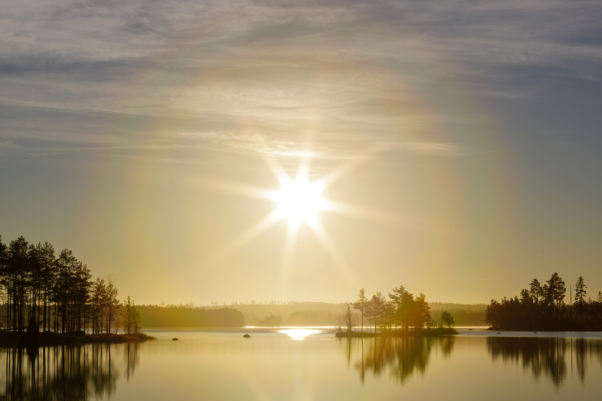 Sun halo above a lake in a winter landscape