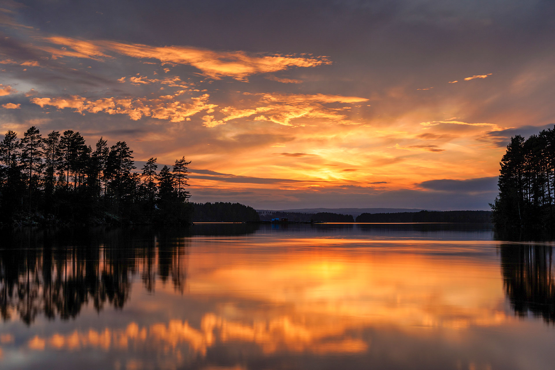 Golden reflections on a calm lake at sunset
