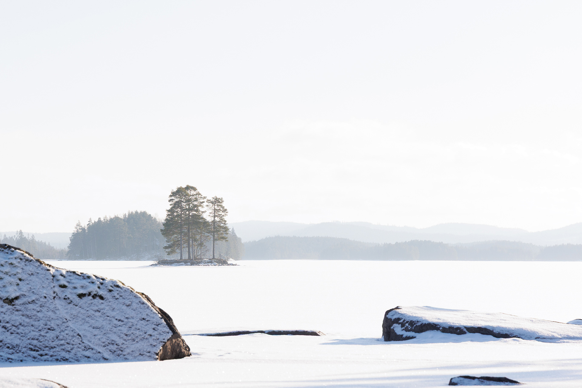 Snow-covered island in a calm lake